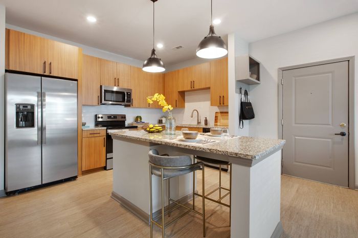Kitchen with subway tile backsplash and spacious white granite countertops at Solis City Park apartments for rent