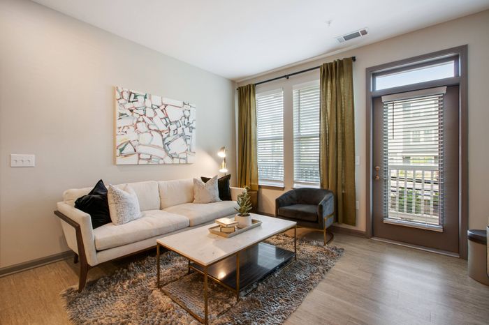 Spacious living room with ample seating and soaring 9-ft. ceilings at Solis City Park apartments for rent
