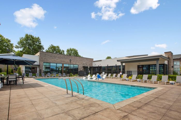 Resort-inspired swimming pool with private cabanas at Solis City Park apartments for rent