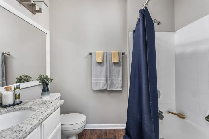 Full bathroom at Memphis apartment for rent with hardwood flooring and large vanity