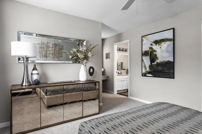 Master bedroom with plush carpeting and in-room bathroom at Memphis apartment for rent