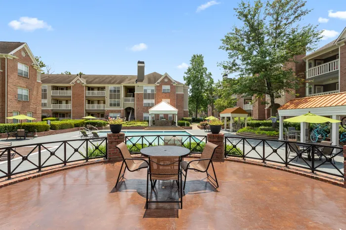 Elegant, outdoor poolside deck with tables and chairs