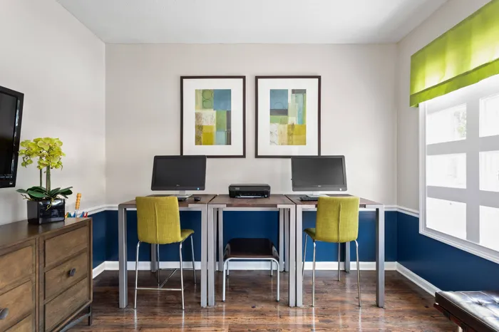 Business center with chairs and computers for residents of Arbors River Oaks Apartment Homes