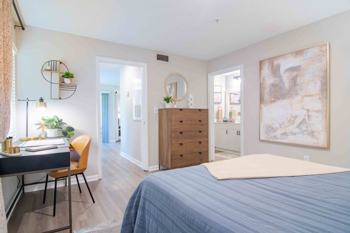Large and efficient bedroom featuring a compact workspace,