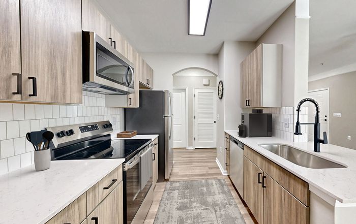 Newly renovated, modern and spacious kitchen with new cabinetry and stainless steel appliances at St. James at Goose Creek apartments for rent