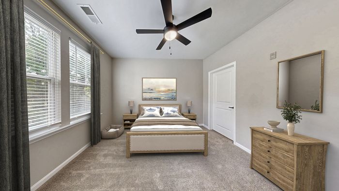 Furnished master bedroom with en-suite bathroom at St. James at Goose Creek apartments for rent in Charleston, SC