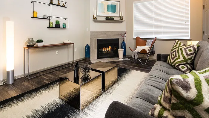 Chic living room with modern decor, featuring a cozy fireplace, stylish sofa, and elegant coffee table, perfect for sophisticated relaxation.