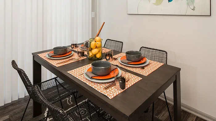 Chic dining area with a modern table setting and vibrant decor, perfect for intimate gatherings.