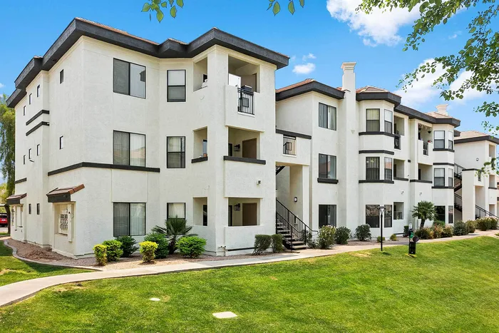 Charming apartment complex showcasing modern architecture with lush green surroundings and vibrant landscaping.