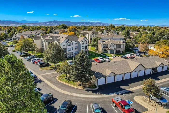 Charming apartment complex surrounded by lush greenery and mountain views, offering a serene residential experience.