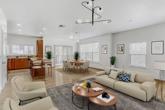 Modern open-concept living space featuring a stylish kitchen with wooden cabinets, chic dining area, and cozy seating arrangement, perfect for entertaining.