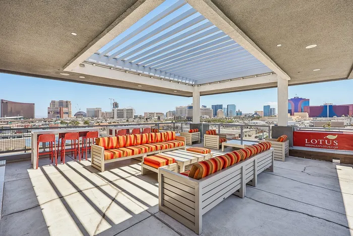 Rooftop lounge with vibrant seating offering panoramic views of the city skyline.