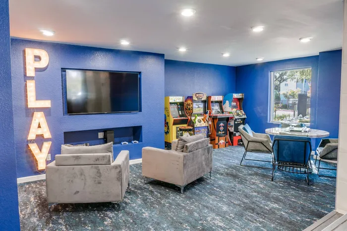 Resident lounge area with TV chairs and arcade gaming