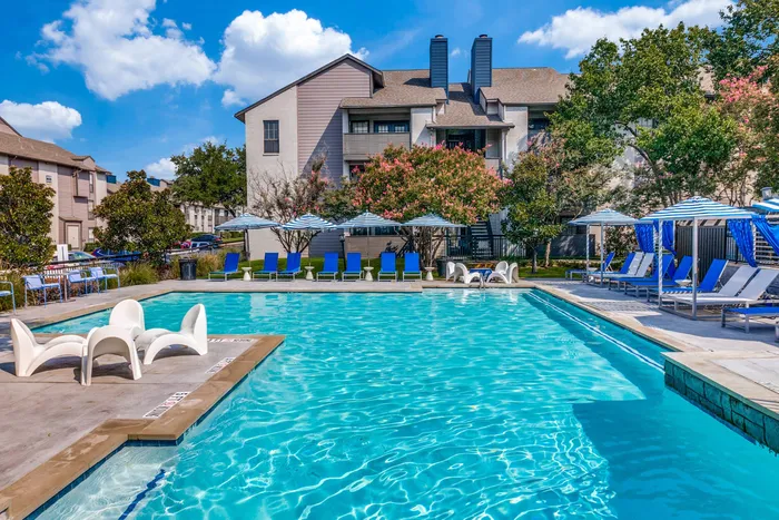 Expansive pool with sundeck and lounge chairs