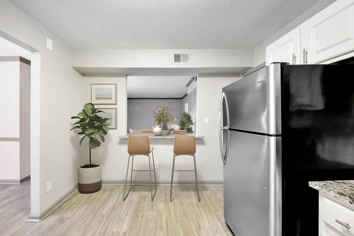 Virtual staging of kitchen and dining room with hardwood floors