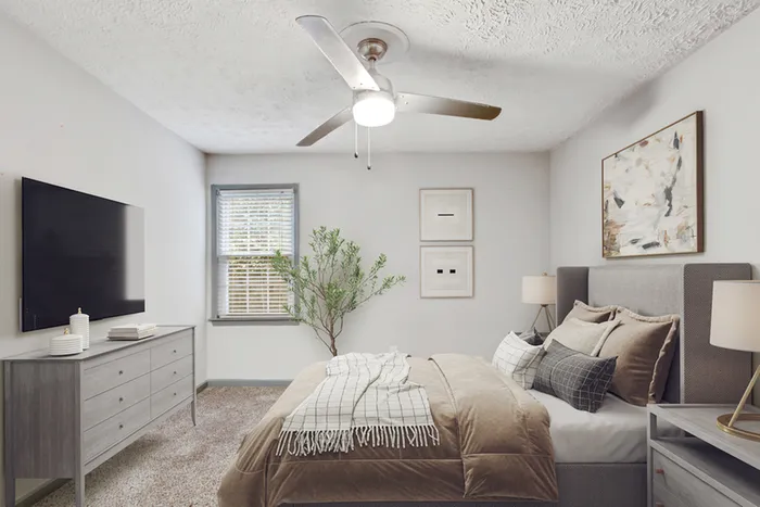 Virtual staging of bedroom with large bed and ceiling fan