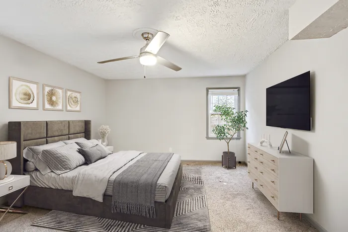 Virtual staging of bedroom with large bed and ceiling fan