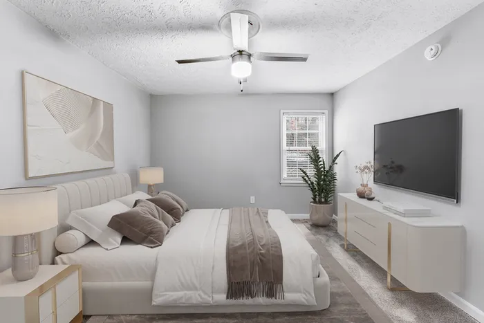 Virtual staging of bedroom with large bed and ceiling fan