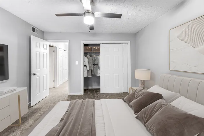 Virtual staging of bedroom with large bed and ceiling fan