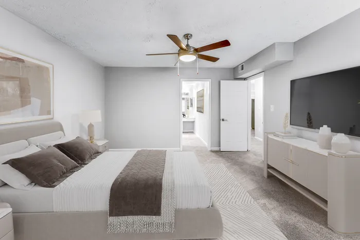 Virtual staging of bedroom with large bed and ceiling fan