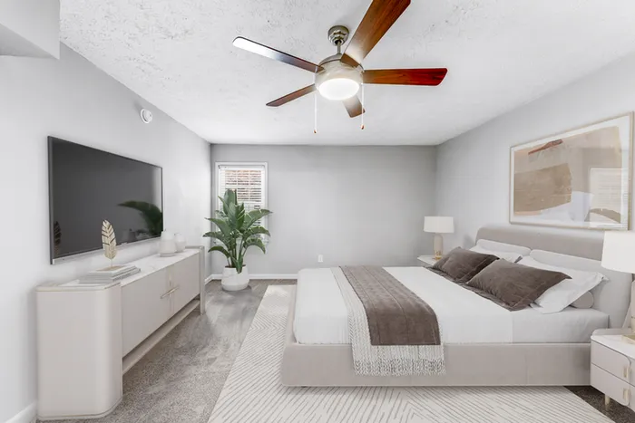 Virtual staging of bedroom with large bed and ceiling fan