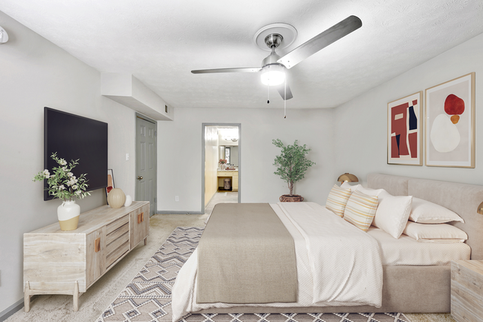 Virtual staging of bedroom with large bed and ceiling fan