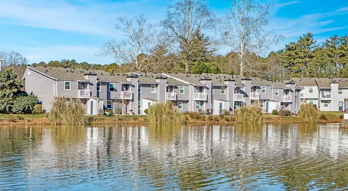Exterior of brick and wood paneled building on lake