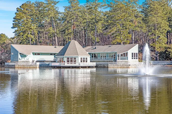 Exterior of brick and wood paneled building on lake