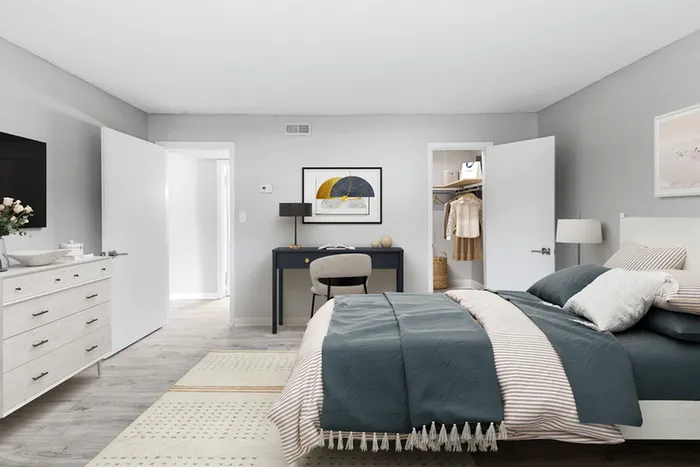 Bed, desk and chair, wall art, and closet