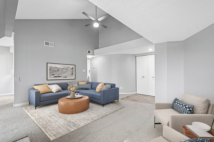 Living room with couch, ceiling fan and table