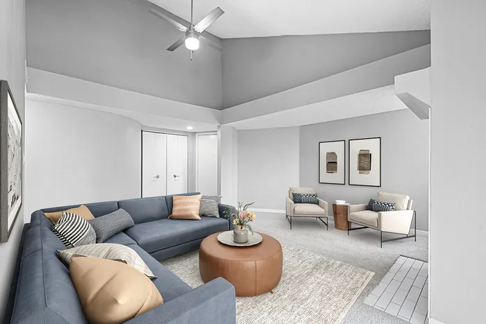 Living room with couch, ceiling fan and table