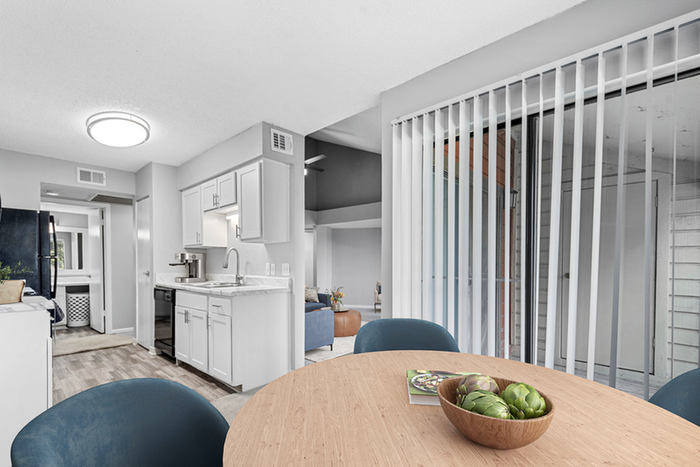 Dining table, chairs, and glass patio door with blinds