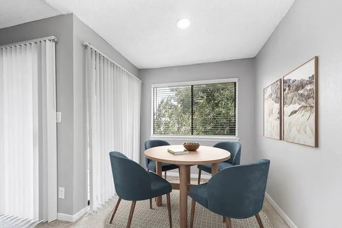 Dining table, chairs, and glass patio door with blinds