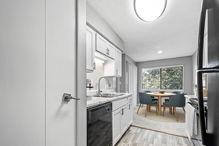 Kitchen with Vinyl floors, stainless-steel appliances, white quartz countertop,
