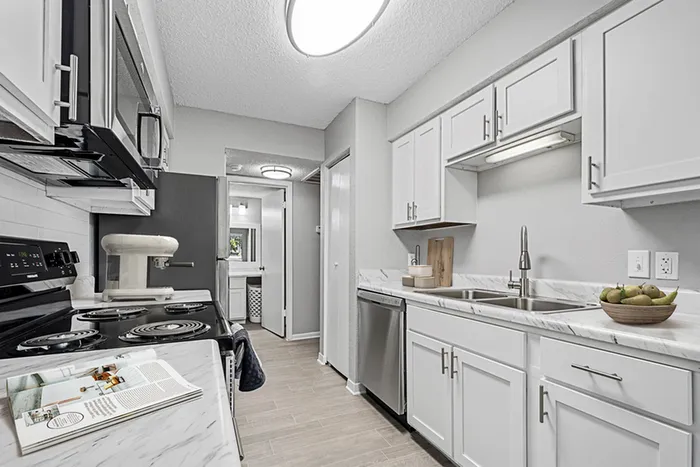 Kitchen with Vinyl floors, stainless-steel appliances, white quartz countertop