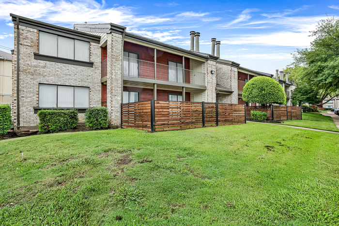 Exterior of brick and wood paneling apartment building