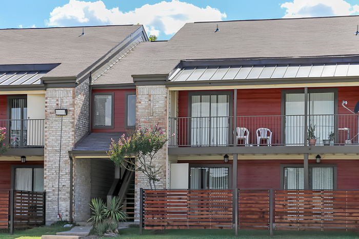 Exterior of brick and wood paneling apartment building