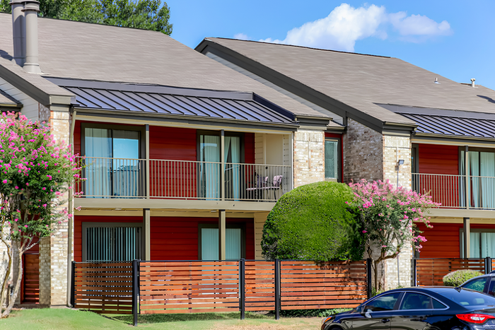 Exterior of brick and wood paneling apartment building