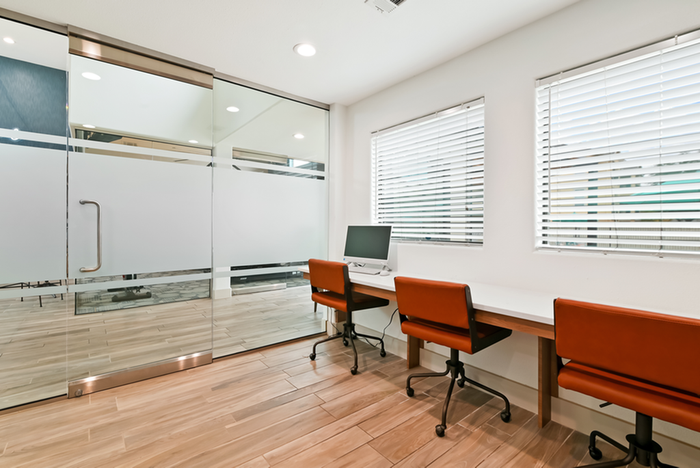 Resident business center, red chairs, computers and windows