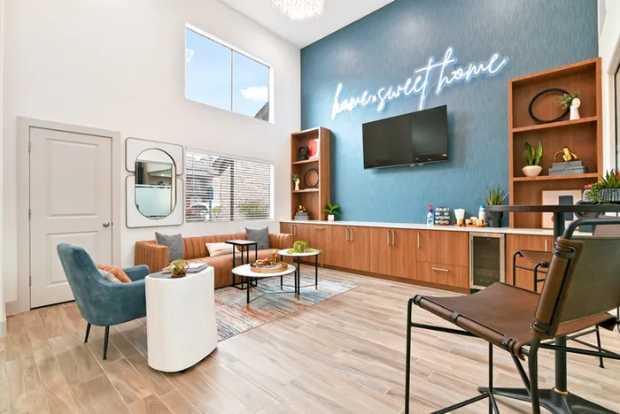 Rssident lounge with TV, chairs and bookshelves