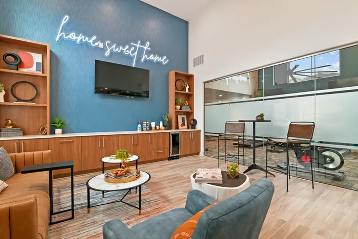 Rssident lounge with TV, chairs and bookshelves