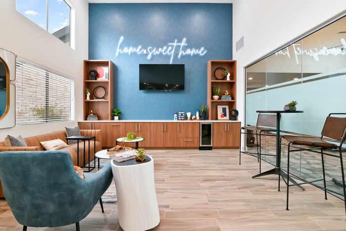 Rssident lounge with TV, chairs and bookshelves