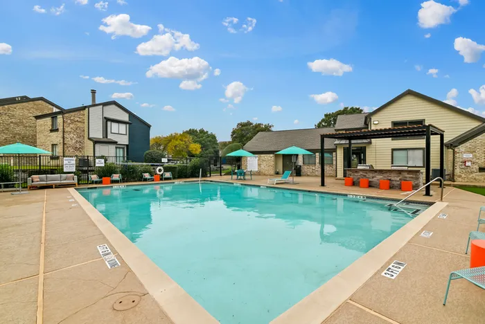 Expansive pool and sundeck with lounge chairs