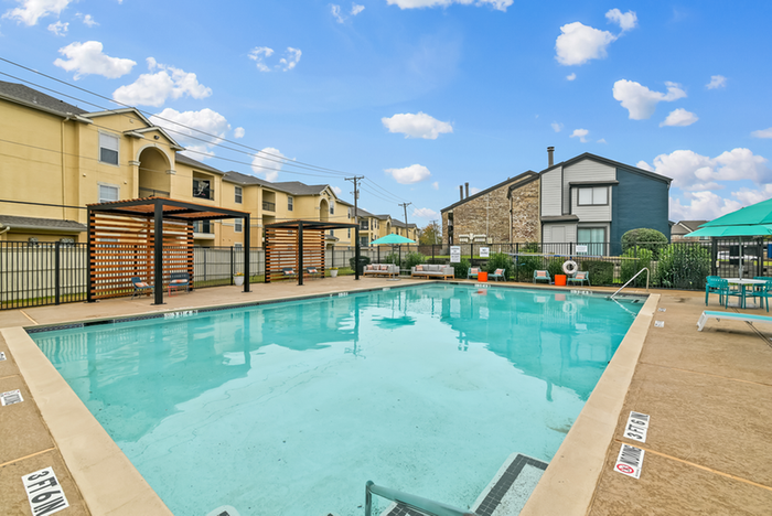 Expansive pool and sundeck with lounge chairs