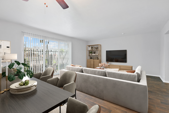 Hard wood style flooring, wooden dinner table, fabric chairs, beige couch, flat screen TV