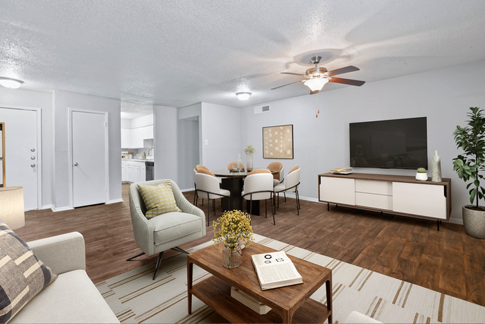 hardwood style flooring, wooded coffee table, rug, entertainment center, ceiling fan light fixture