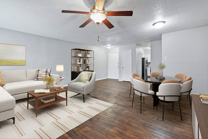 Hardwood style flooring, beige rug, beige sectional couch, ceiling fan, wood coffee table, dining table and chairs