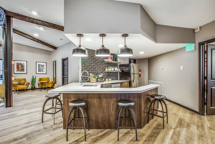 Resident lounge kitchenette with bar and bar chairs