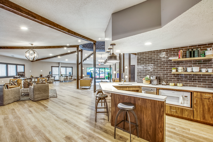 Resident lounge kitchenette with bar and bar chairs