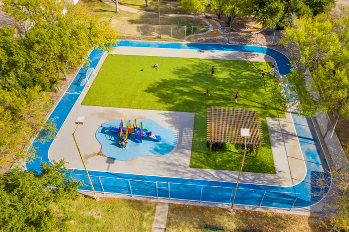 Exterior sports area with soccer field, playground, covered seating area